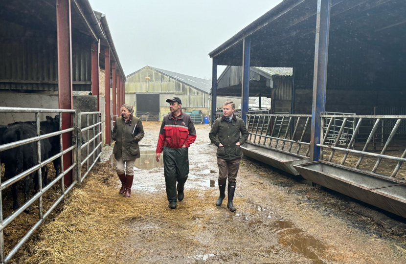 Bradley walking with a local farmer and NFU representative Emma Hamer