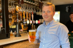 Bradley with a pint at the bar.