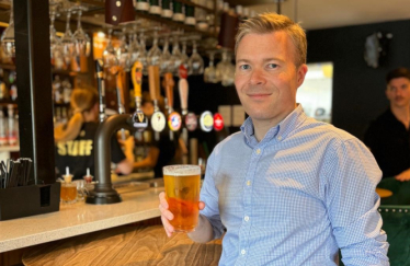 Bradley with a pint at the bar.